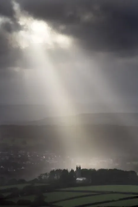 Framed Print : Walkhampton Church lit by sunlight in heavy rain, Walkhampton, Dartmoor, Devon, England