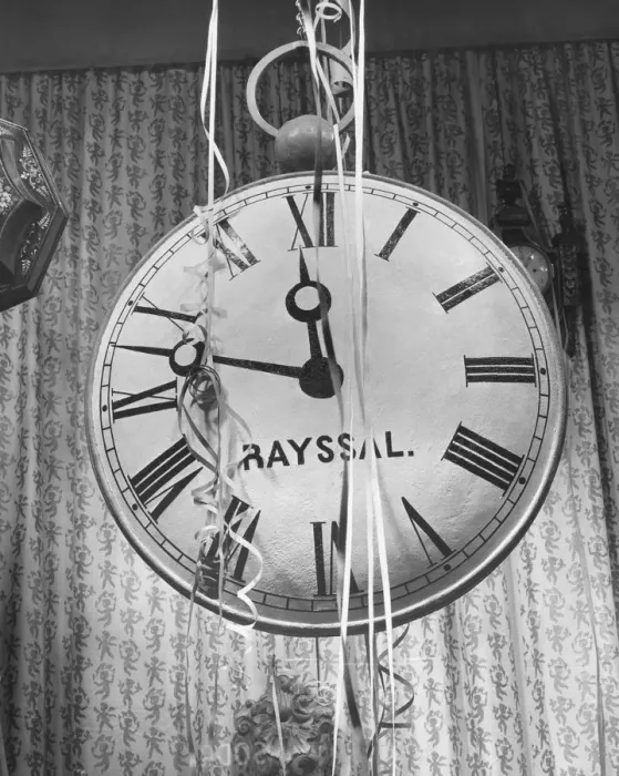 Framed Print : Wall clock covered in party streamers, (B&W) Framed Print : Wall clock covered in party streamers, (B&W)