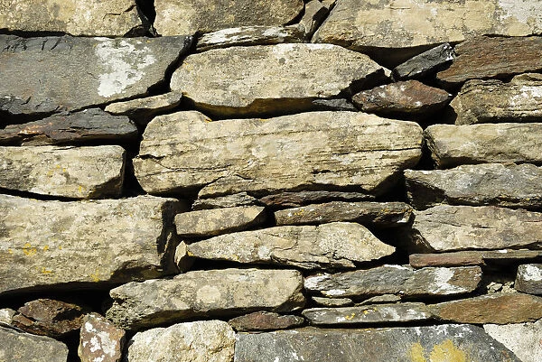 Wall of the historic early christian Saint Columcille abbey, constructed from piled up stones, Co Donegal Ireland