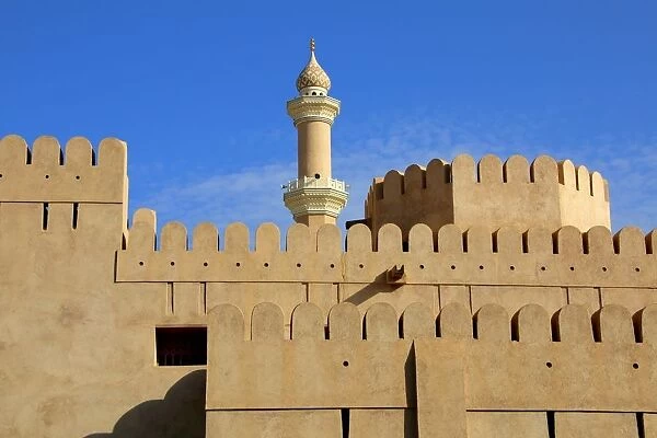 Walls of the Nizwa fort and the minaret