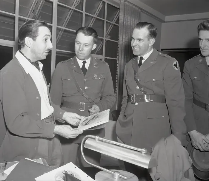 Framed Print : Walt Disney Discussing Insignia with Air Corps Officer Framed Print : Walt Disney Discussing Insignia with Air Corps Officer