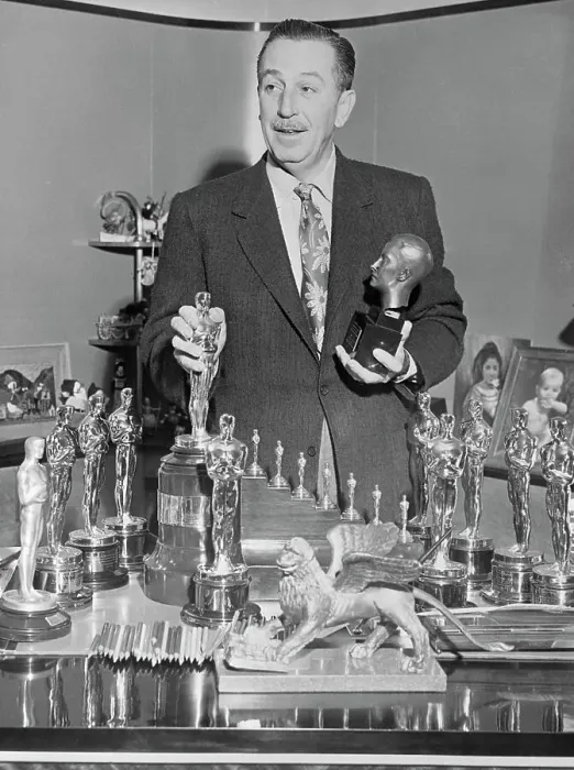 Framed Print : Walt Disney Standing over Table of Trophies