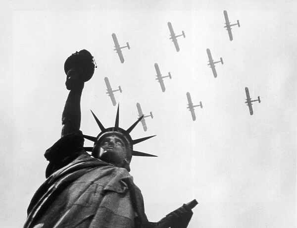 War Birds. circa 1935: Military aircraft fly over the Statue of Liberty, New York