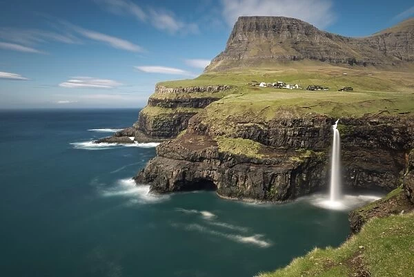 Waterfall on the cliffs near a village, Gasadalur, Vagar, Faroe Islands, Denmark