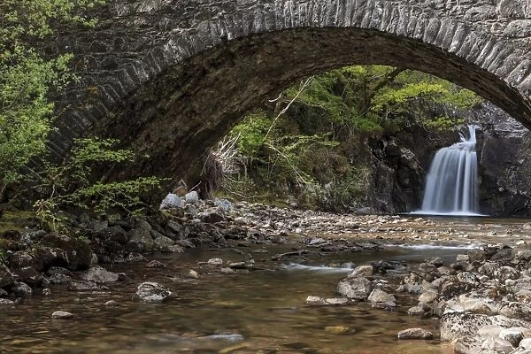 Waterfall behind an old stone bridge, Drumnadrochit, Scotland, United Kingdom