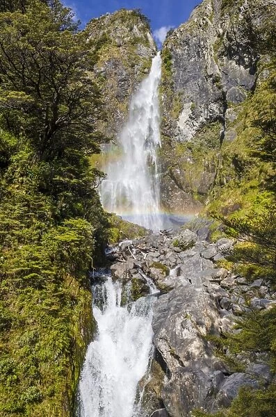 Waterfall with a rainbow on Arthurs Pass, South Island, New Zealand, Oceania