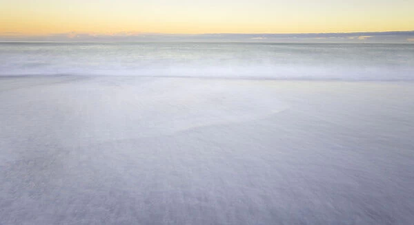 Waves breaking on beach, dawn, (long exposure)