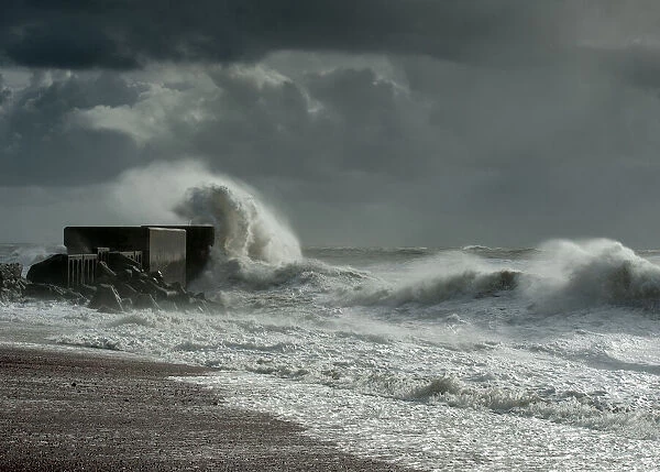 Storm. Waves breaking over the Hastings harbour wall during storms on 2013