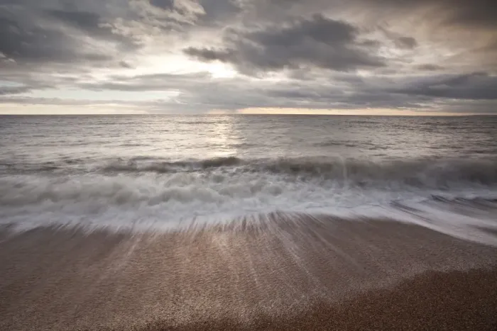 Framed Print : Waves crashing over the beach at Burton Bradstock Framed Print : Waves crashing over the beach at Burton Bradstock