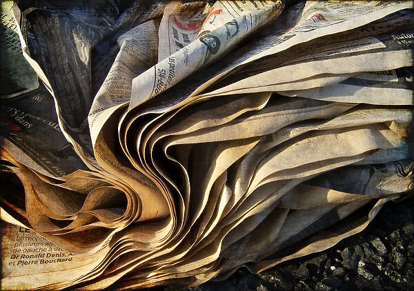 Paper. Weathered newspaper folds photographed in late afternoon sunlight