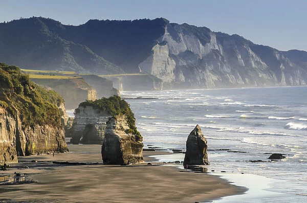 White Cliffs Beach at low tide, rocks in the surf, Ahititi, Taranaki, North Island, New Zealand