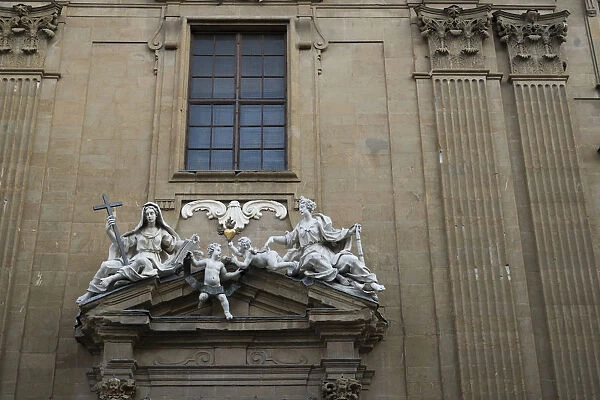 White marble sculptures on the facade of a building in Florence