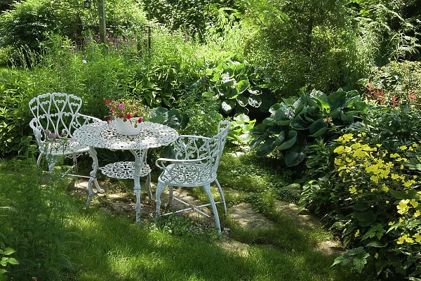 White metal garden table and chairs in a residential backyard, Quebec City, Quebec Province, Canada
