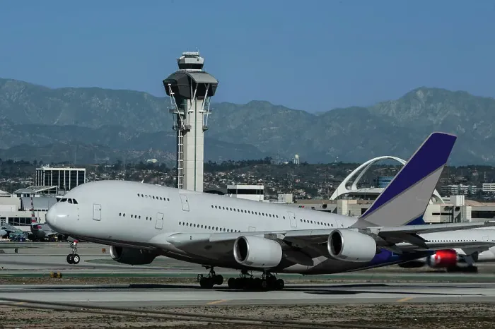 Framed Print : Wide body airliner taking off at Los Angeles International Airport (LAX) with control tower in background Framed Print : Wide body airliner taking off at Los Angeles International Airport (LAX) with control tower in background