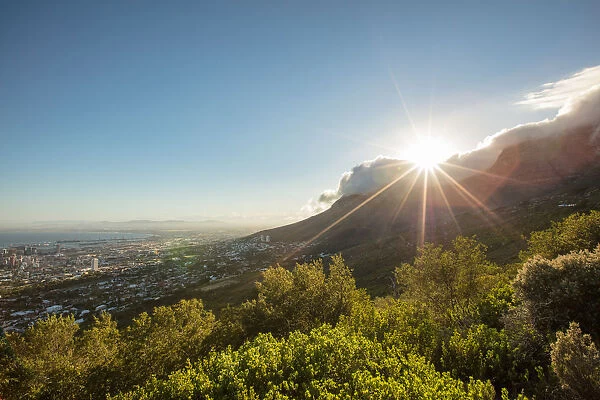 Wide shot of the sun rising over Table Mountain, Cape Town, Western Cape, South Africa
