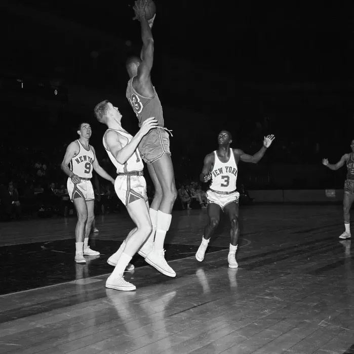 Framed Print : Wilt Chamberlain Jumping Holding Ball