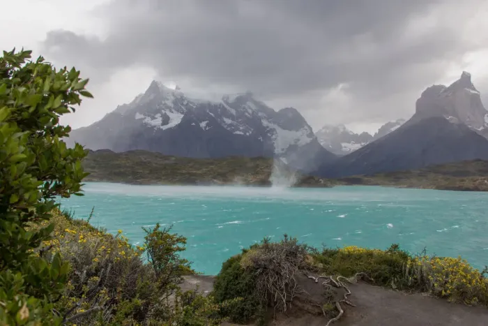 Framed Print : The wind whips up waves and a waterspout across the cold waters of Lake Pehue to the snow-capped mountain peaks of the Torres del Paine National Park in the Magallanes Region of Patagonia, Southern Chile Framed Print : The wind whips up waves and a waterspout across the cold waters of Lake Pehue to the snow-capped mountain peaks of the Torres del Paine National Park in the Magallanes Region of Patagonia, Southern Chile