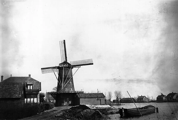 Windmill. circa 1925: A windmill on the polderland (land reclaimed from water) in Holland
