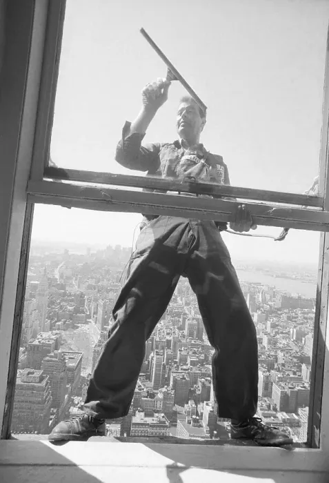 Framed Print : Window Washer Hanging Outside Window Framed Print : Window Washer Hanging Outside Window