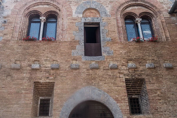 Windows, brick building, San Gimignano, Italy