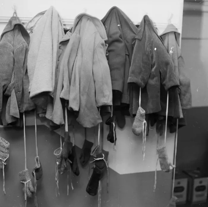 Framed Print : Winter Wear; row of small coats and mittens hanging Framed Print : Winter Wear; row of small coats and mittens hanging