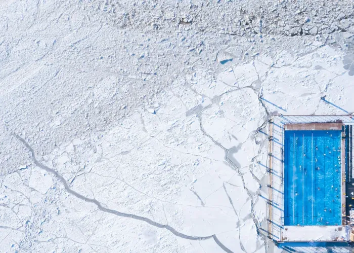 Framed Print : Wintery top-down aerial view of a heated swimming pool next to frozen Baltic sea