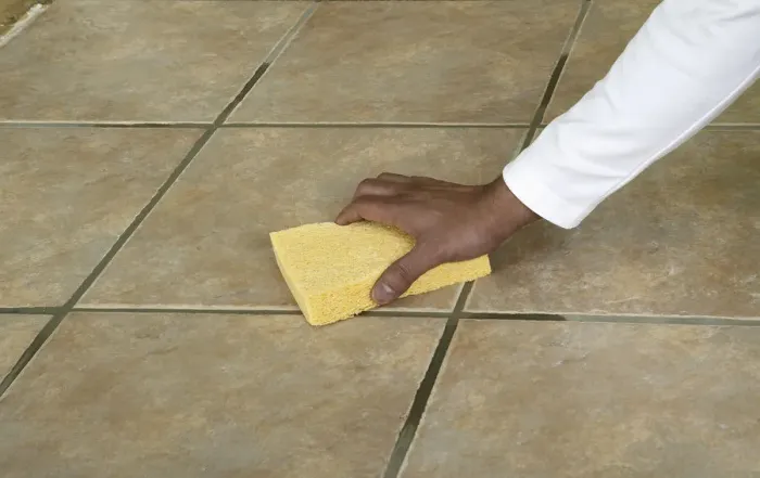 Framed Print : Wiping the surface of a tiled floor with a sponge