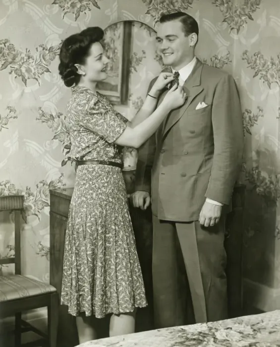 Framed Print : Woman adjusting mans tie at dressing table Framed Print : Woman adjusting mans tie at dressing table