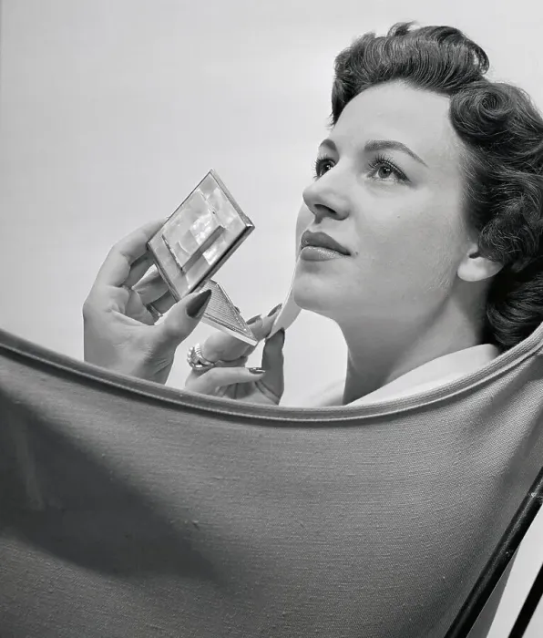 Framed Print : Woman Applying Makeup with a Compact Framed Print : Woman Applying Makeup with a Compact
