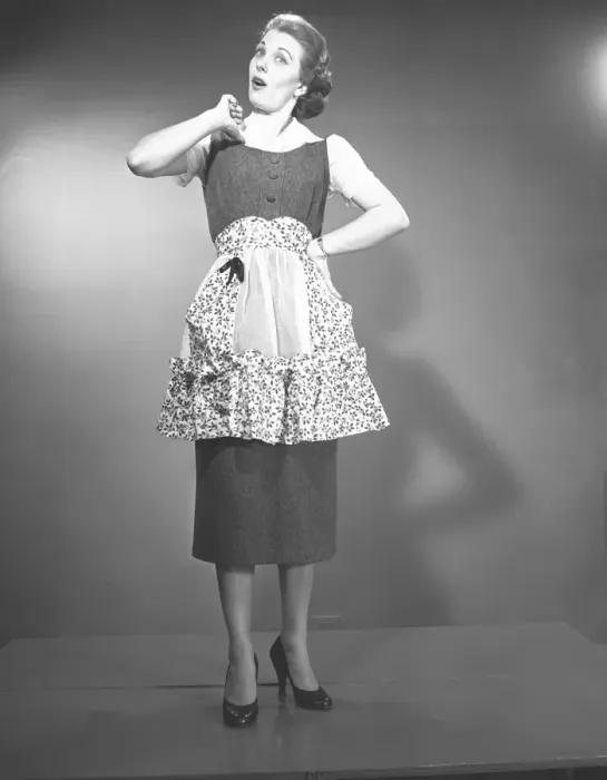 Framed Print : Woman in apron posing in studio, (B&W), , portrait Framed Print : Woman in apron posing in studio, (B&W), , portrait