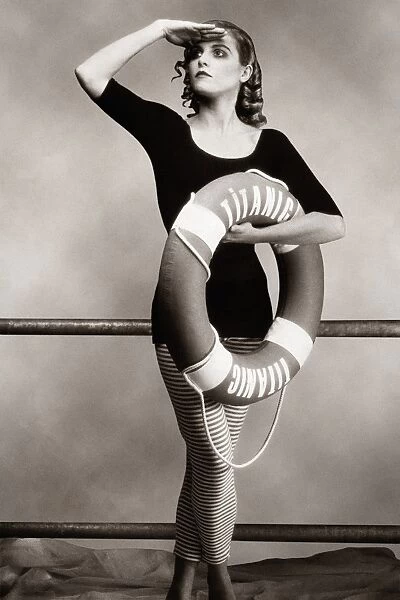 Woman in bathing costume holding life preserver