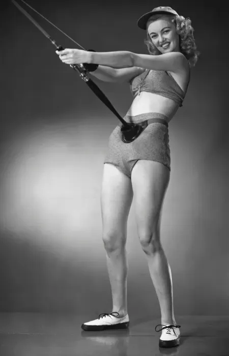 Framed Print : Woman in beachwear holding fishing rod Framed Print : Woman in beachwear holding fishing rod