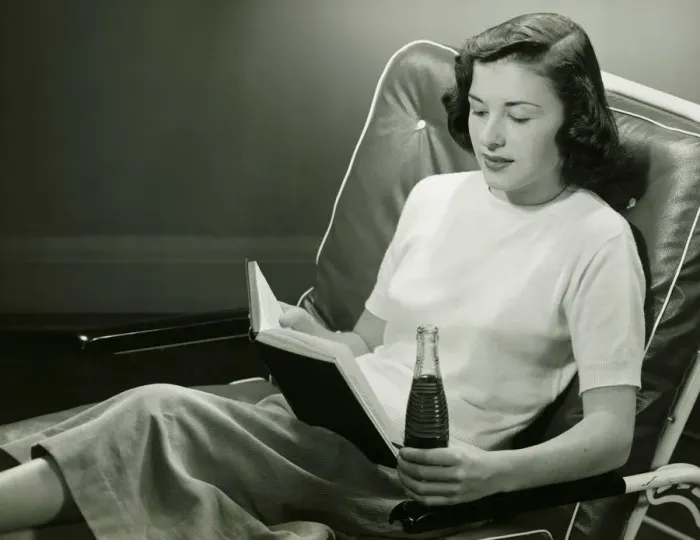 Framed Print : Woman with bottle of beverage, reading book, (B&W) Framed Print : Woman with bottle of beverage, reading book, (B&W)