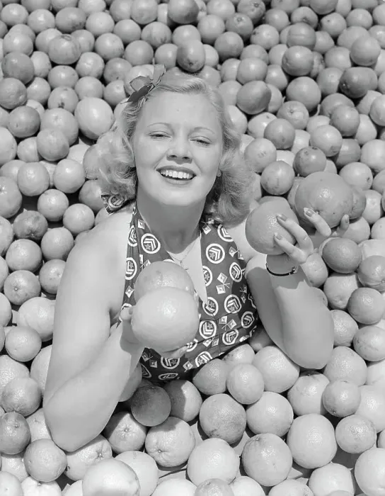 Framed Print : Woman Buried in Pile of Oranges Framed Print : Woman Buried in Pile of Oranges