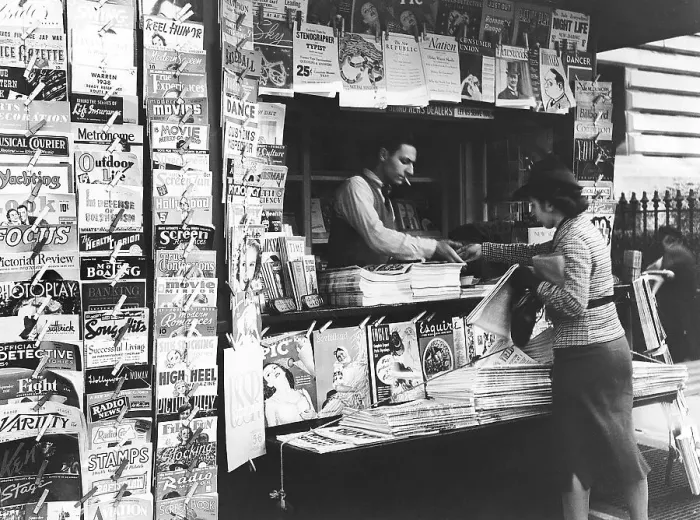 Framed Print : Woman Buys Magazine at Newsstand