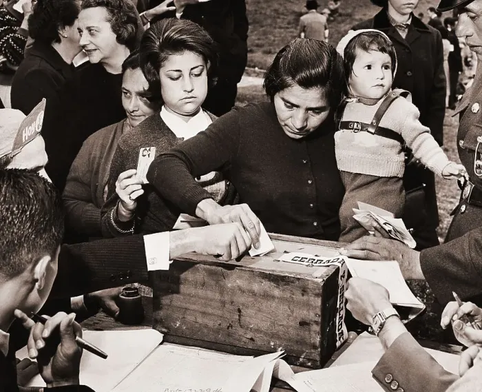 Framed Print : Woman Carrying Child Deposits Ballot Framed Print : Woman Carrying Child Deposits Ballot