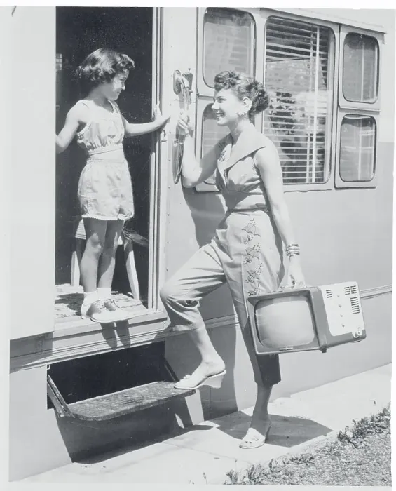 Framed Print : Woman Carrying a Portable Television Framed Print : Woman Carrying a Portable Television