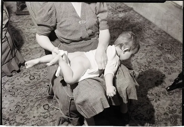 Framed Print : Woman Changing Baby on Lap Framed Print : Woman Changing Baby on Lap