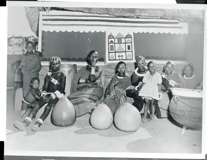 Framed Print : Woman and Children Sitting in Front of a Hut Framed Print : Woman and Children Sitting in Front of a Hut