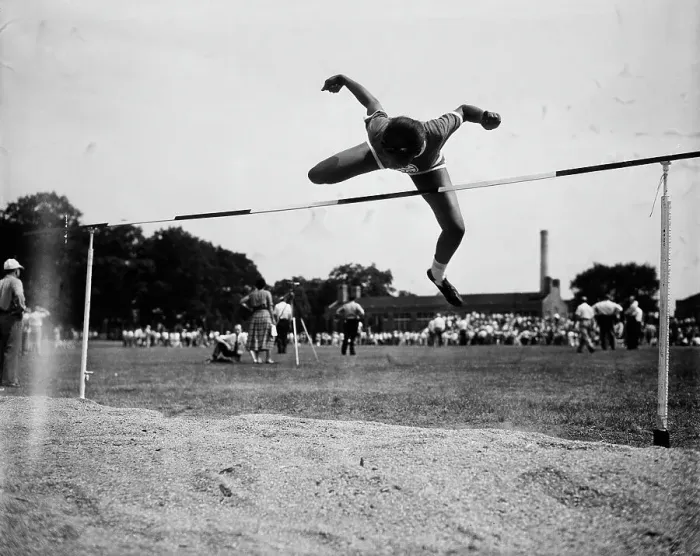 Framed Print : Woman Clearing Bar In High Jump