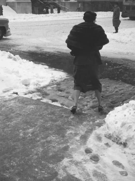 Framed Print : Woman crossing street in winter, (B&W), (rear view) Framed Print : Woman crossing street in winter, (B&W), (rear view)