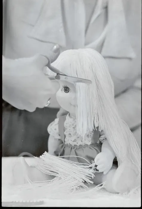 Framed Print : Woman Cutting Doll's Hair Framed Print : Woman Cutting Doll's Hair