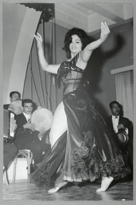 Framed Print : Woman Dancing in Front of Men Framed Print : Woman Dancing in Front of Men