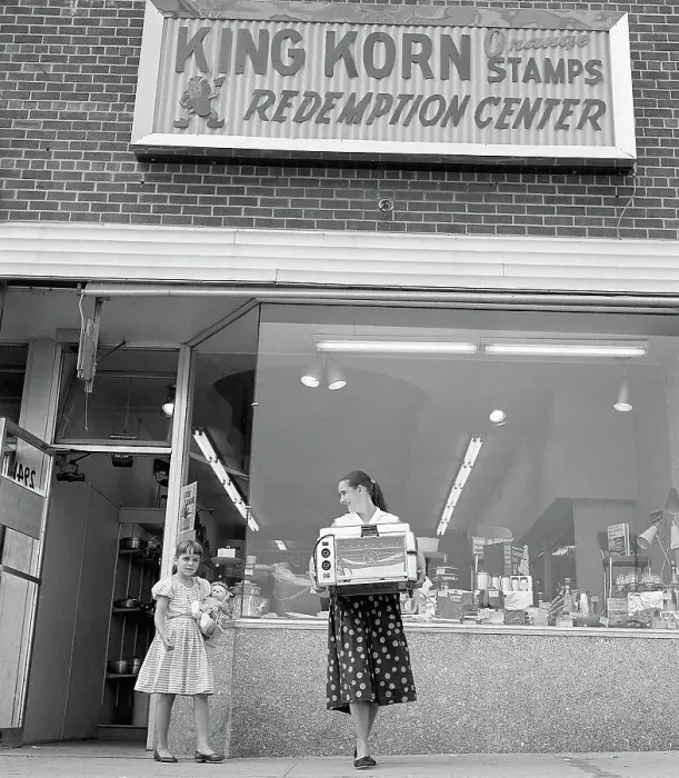 Framed Print : Woman and Daughter Leave Store Framed Print : Woman and Daughter Leave Store