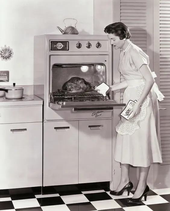 Framed Print : Woman Demonstrating Modern Oven for Cooking Framed Print : Woman Demonstrating Modern Oven for Cooking