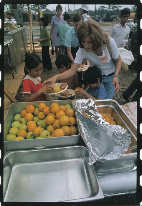 Framed Print : Woman Distributing Food to a Refugee Framed Print : Woman Distributing Food to a Refugee