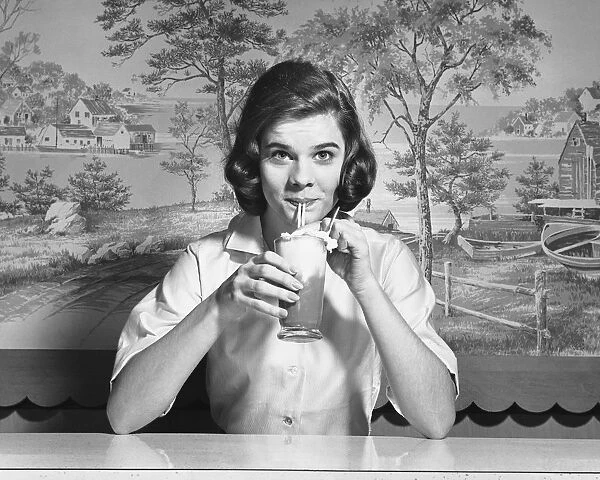 Woman drinking ice cream soda