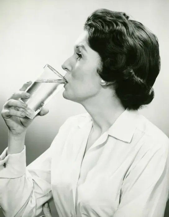 Framed Print : Woman drinking water, posing in studio, (B&W), (Portrait) Framed Print : Woman drinking water, posing in studio, (B&W), (Portrait)
