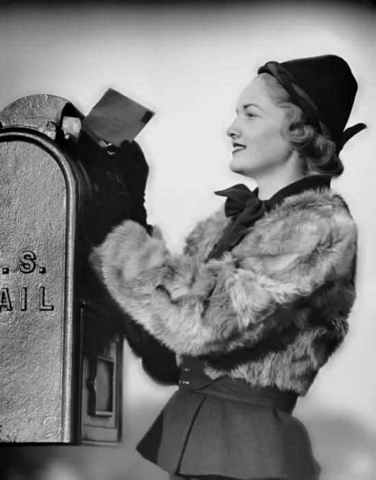 Framed Print : Woman dropping letter into mailbox Framed Print : Woman dropping letter into mailbox