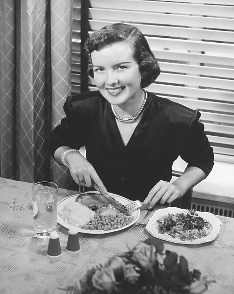 Woman eating dinner (B&W), elevated view